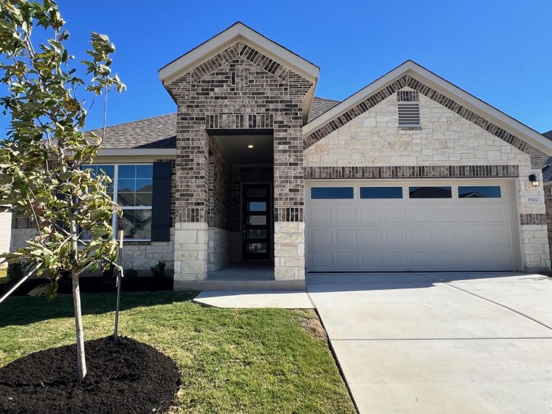 Front exterior of a new home in Rosenbusch Ranch, Leander, TX, highlighting curb appeal (Image 1). Front exterior of a new home in Rosenbusch Ranch, Leander, TX, highlighting curb appeal (Image 1).