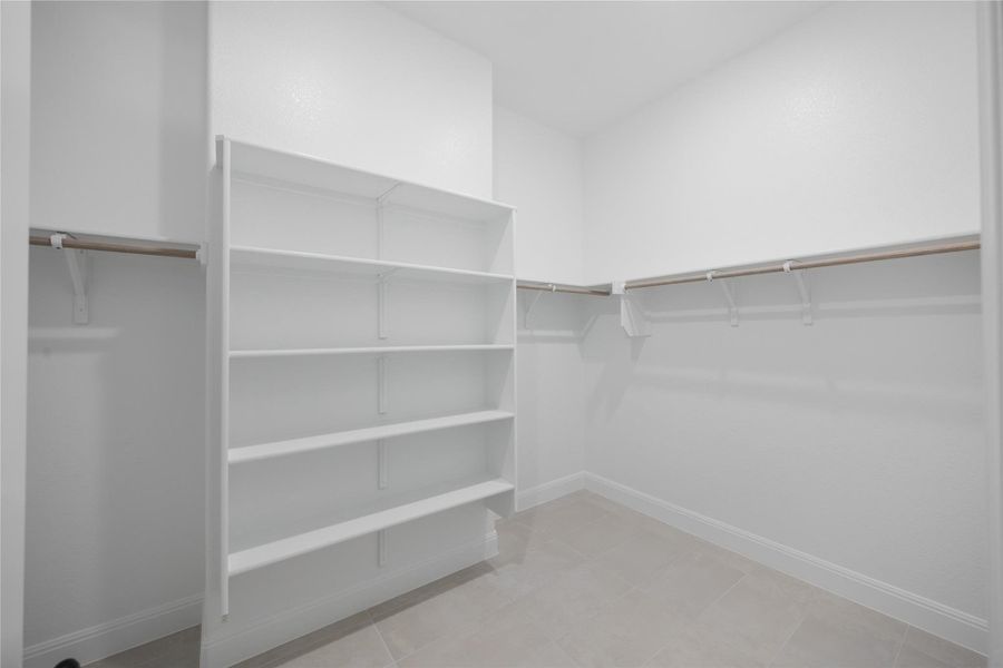 View of primary walk in closet