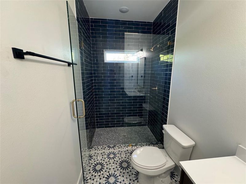 Bathroom with walk in shower, vanity, and toilet