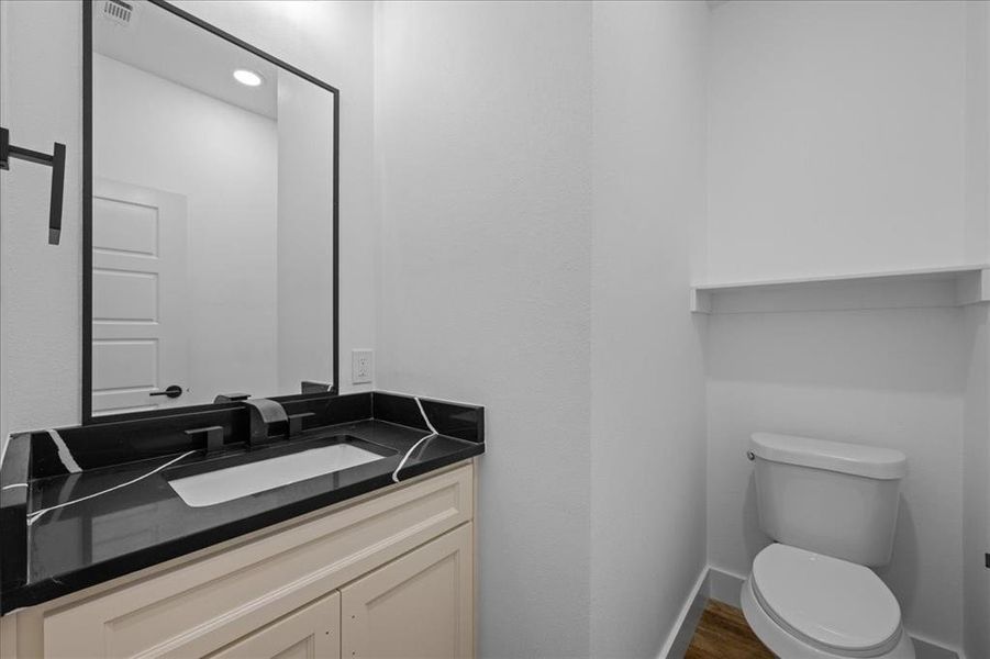 Bathroom with vanity, wood-style floors, and recessed lighting