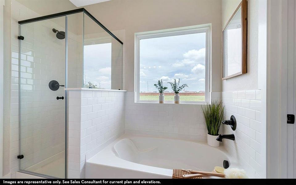 White subway tile surround featuring a built-in tub and a separate glass-enclosed shower with matte black fixtures