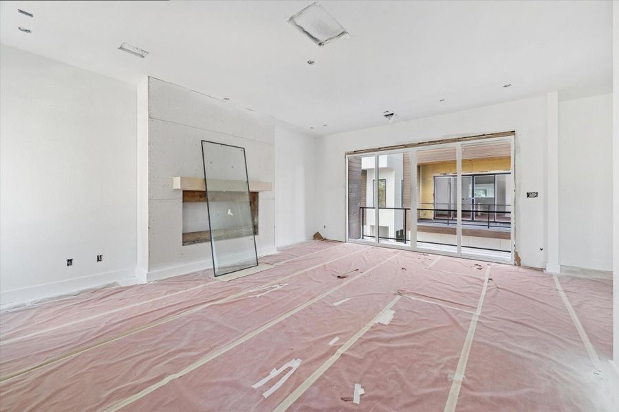 View of the living room and sliding glass doors leading to the balcony as of December 12, 2025.