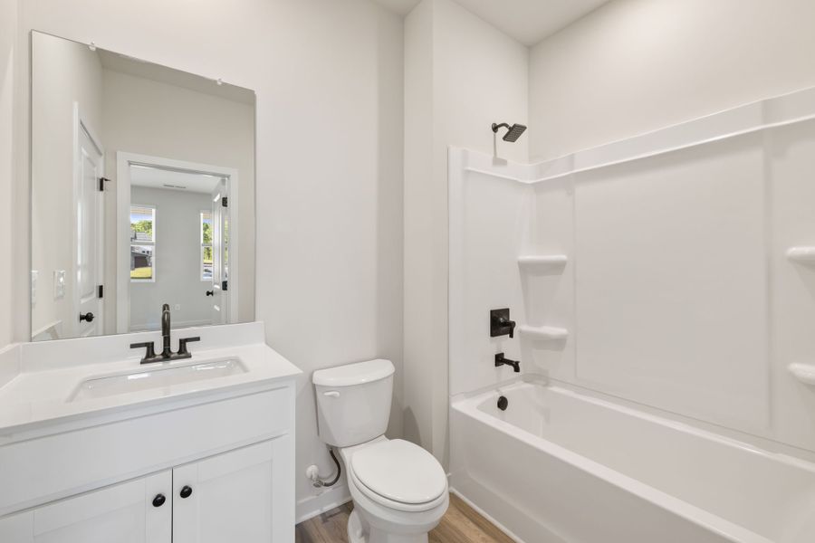 A bathroom with a tub toilet and sink.