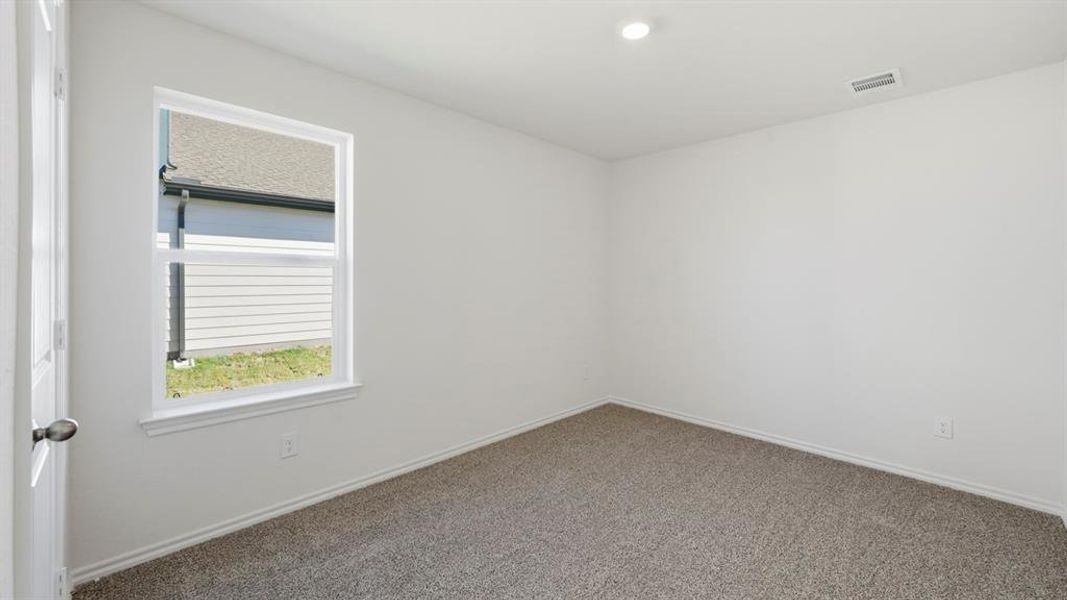Unfurnished room featuring carpet flooring and baseboards Unfurnished room featuring carpet flooring and baseboards