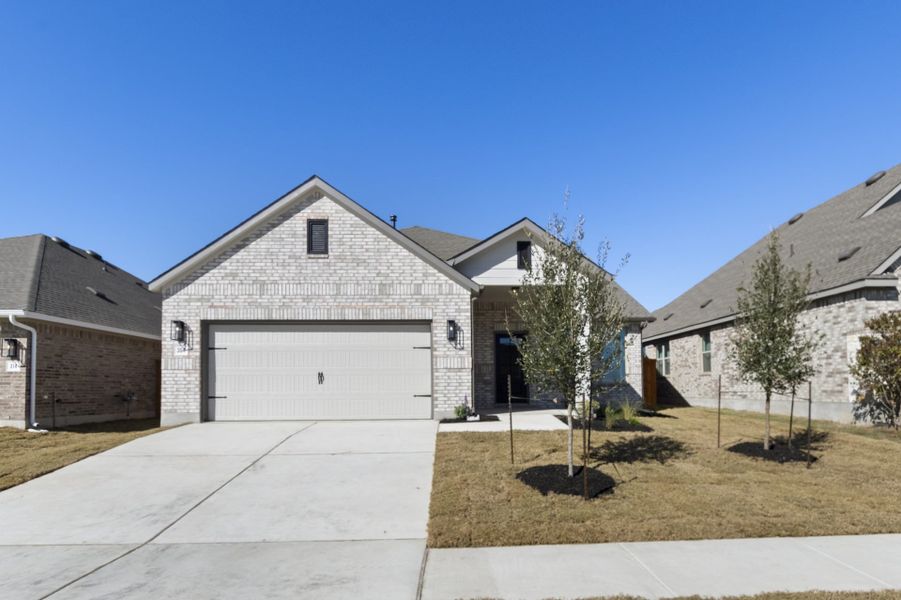 Front exterior of a new home in Crosswinds, Kyle, TX, highlighting curb appeal (Image 25).