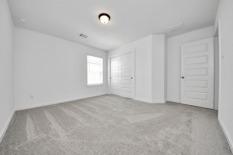 Generously sized secondary bedrooms featuring spacious closets, soft and inviting carpeting underfoot, large windows allowing plenty of natural light, and the added touch of privacy blinds for your personal retreat.