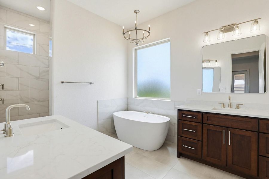Indulge in a tranquil retreat featuring a spacious shower and a freestanding soaking tub.