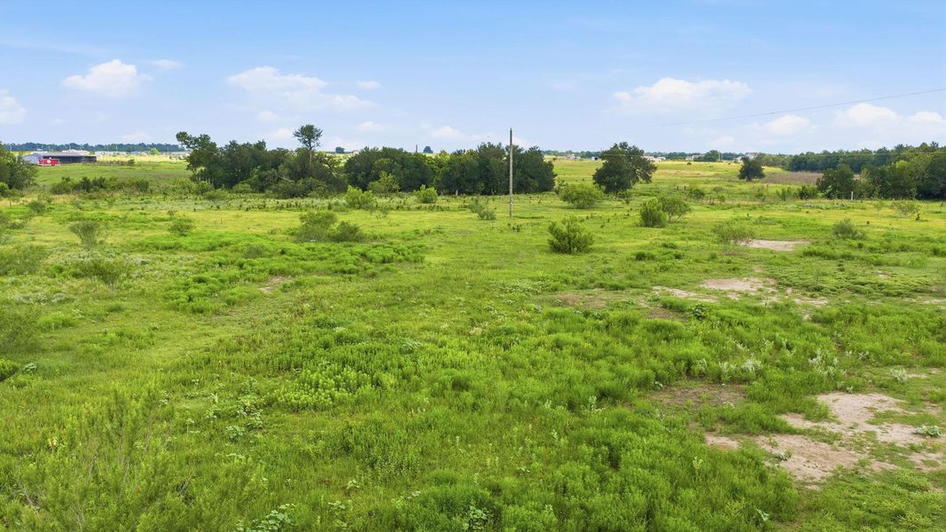 A vast, verdant lot awaits your vision, promising ample space for expansion.