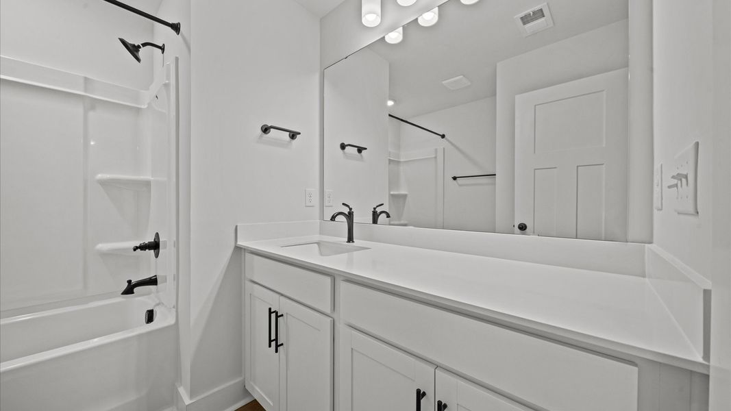 Vibrant and welcoming bathroom with elegant countertop space and polished details