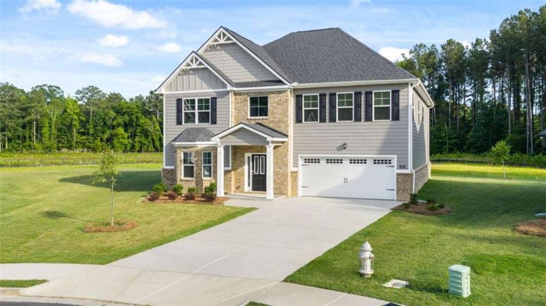 Front exterior of a new home in Wildwood, Covington, GA, highlighting curb appeal (Image 1).