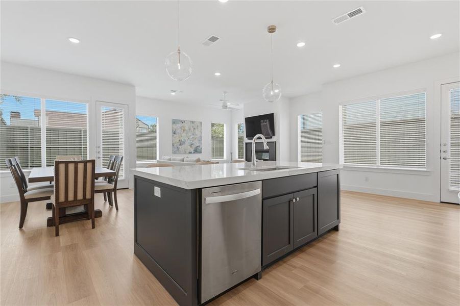 Open-concept living area featuring light wood-finish flooring throughout