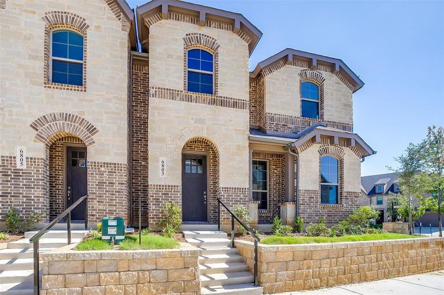 View of front of house with brick siding and stone siding View of front of house with brick siding and stone siding