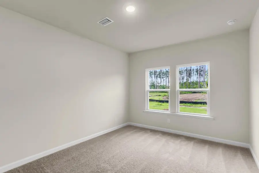 Tranquil primary suite with plush carpet and spa-like feel.