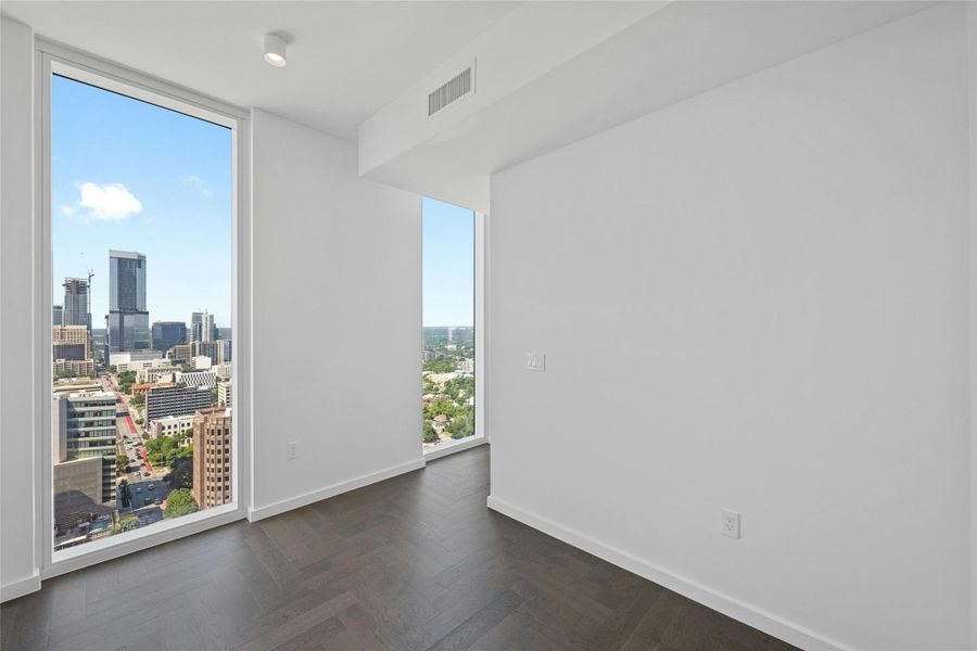 A private den with panoramic urban views, providing valuable flex space for an office, studio or additional sleeping area.