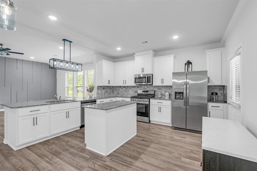 The neutral colors of the kitchen cabinets and granite countertops provide a blank canvas for your favorite decorations.