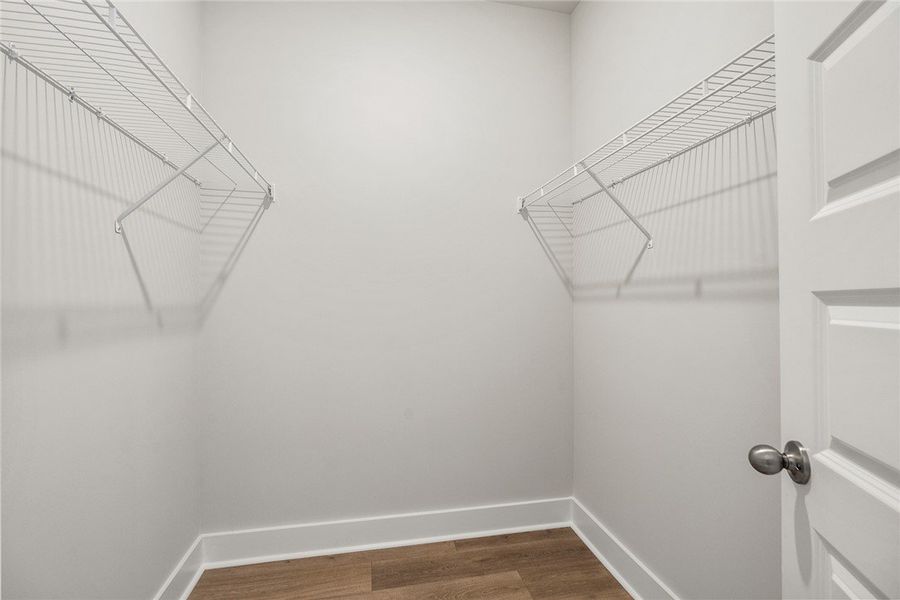 A well-organized walk-in closet with ample wire sh A well-organized walk-in closet with ample wire sh