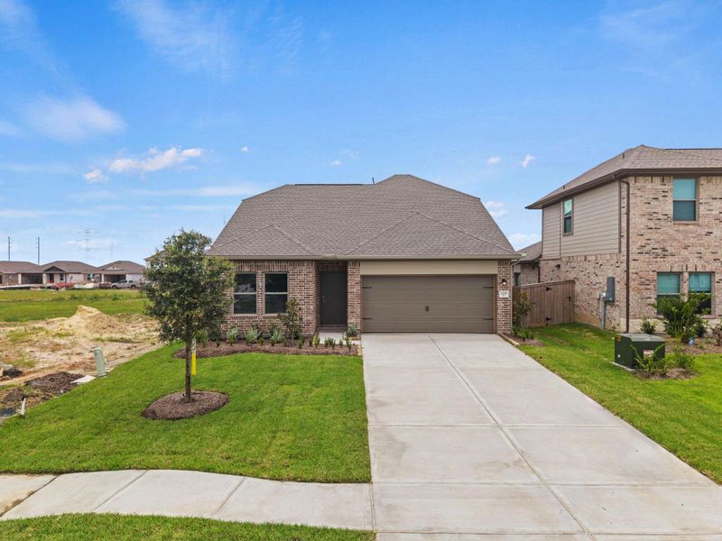 Front exterior of a new home in Windrose Green, Angleton, TX, highlighting curb appeal (Image 2). Front exterior of a new home in Windrose Green, Angleton, TX, highlighting curb appeal (Image 2).