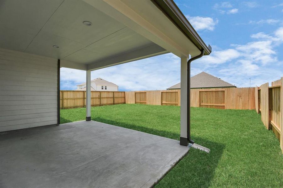 Experience outdoor living at its finest on this expansive covered patio, thoughtfully designed for BBQs and delightful outdoor dining. Sample photo of similar plan. Actual colors and selections may vary.