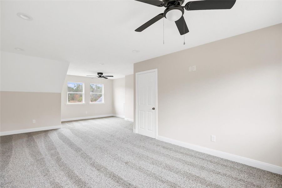 Everyone will love this upstairs game room! What a great niche area for a desk providing back yard views!
