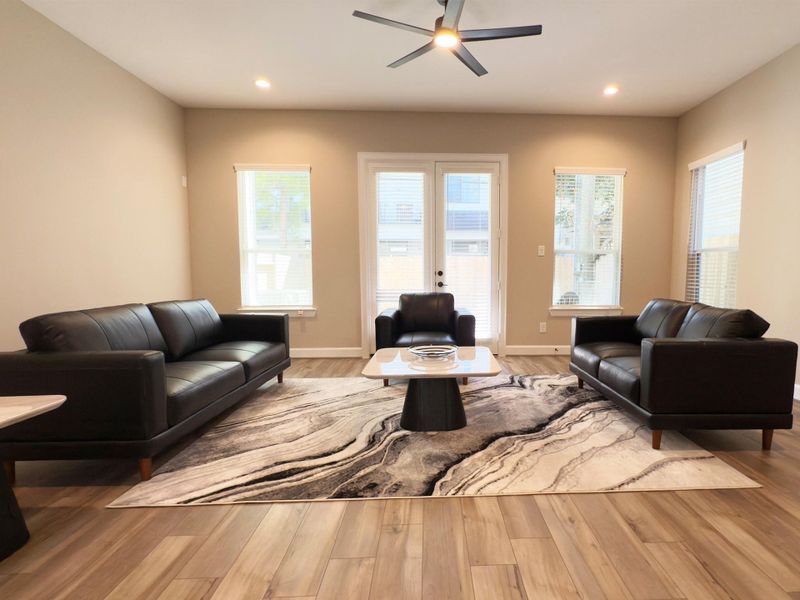 The ROCburne’s living room is designed for both comfort and style, featuring soaring ceilings, abundant natural light, and an open flow that seamlessly connects to the kitchen and dining areas—perfect for both everyday living and entertaining. Image depicts home as-is.