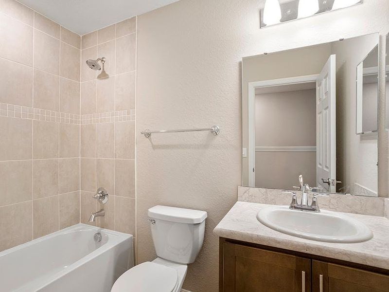 An upstairs hall bath serves your secondary bedrooms - Daisy townhome by Highland Homes