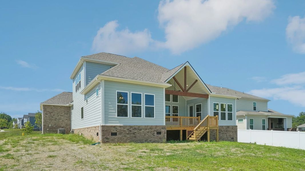 Rear exterior view of two-story home featuring back porch