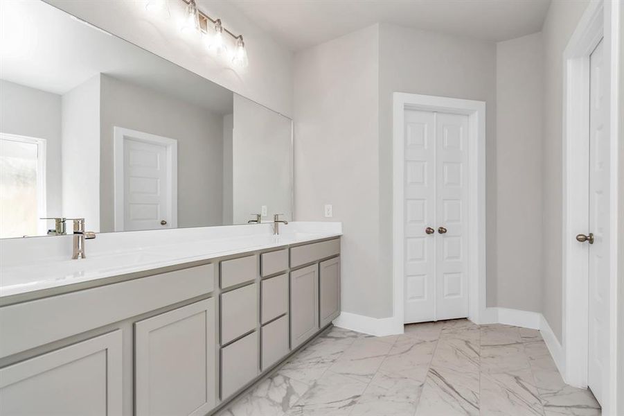 Experience a spa-like escape right in the heart of your primary bathroom. Sample photo of completed home. Actual colors and selections may vary.