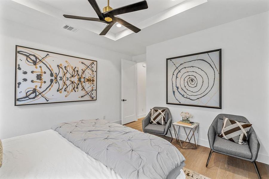 Bedroom with ceiling fan and hardwood / wood-style floors