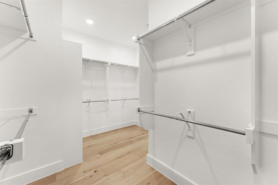 Spacious closet featuring light hardwood / wood-style flooring