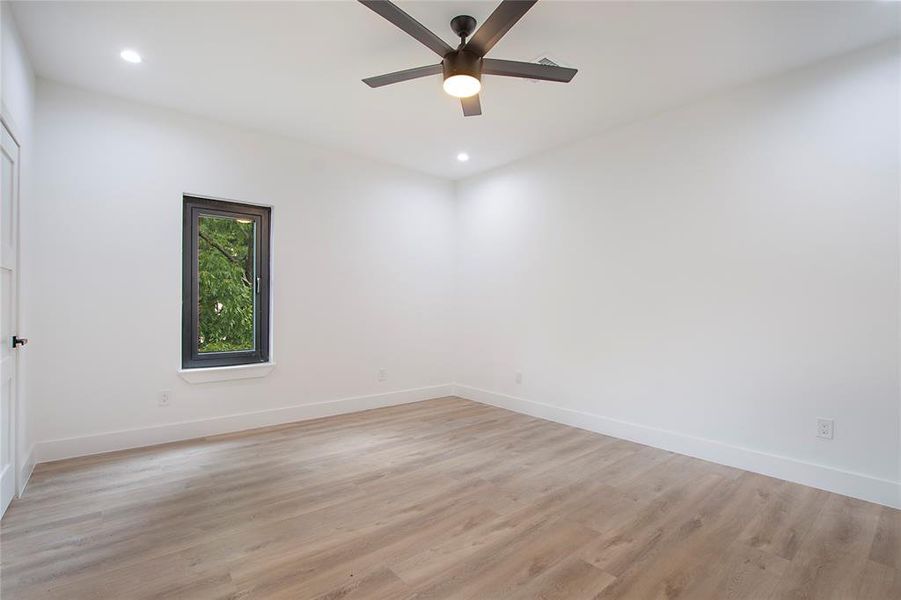 Unfurnished room with ceiling fan and light hardwood / wood-style floors