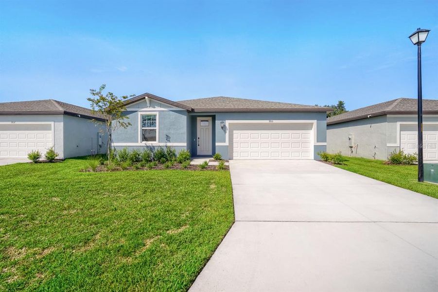 Front exterior of a new home in Salt Meadows - Classic Series, Parrish, FL, highlighting curb appeal (Image 1). Front exterior of a new home in Salt Meadows - Classic Series, Parrish, FL, highlighting curb appeal (Image 1).