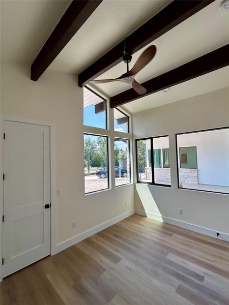 Unfurnished room featuring ceiling fan and light wood-style flooring Unfurnished room featuring ceiling fan and light wood-style flooring