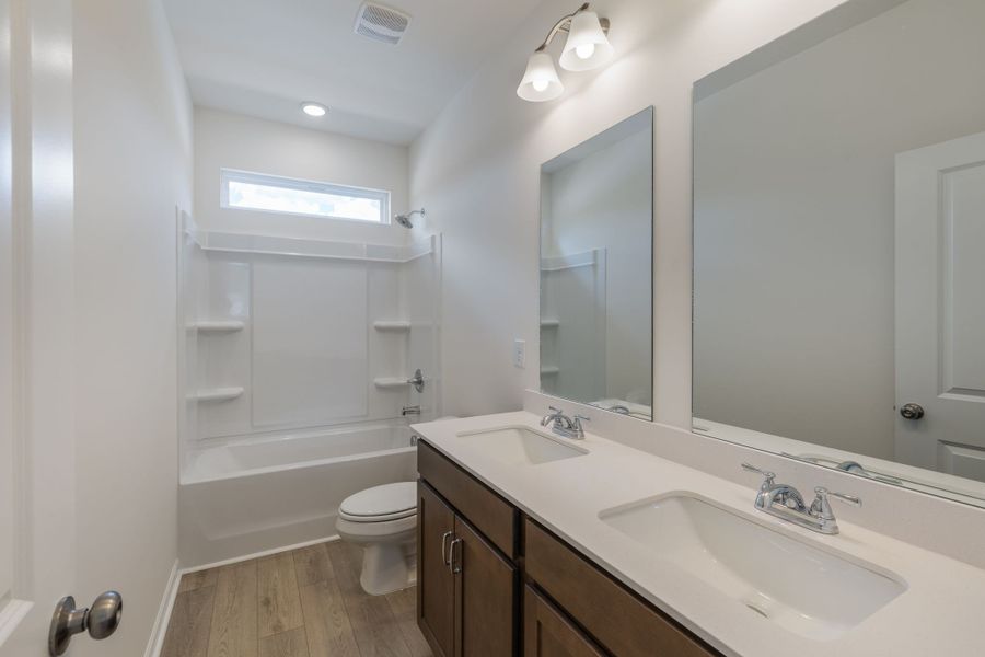 Hall bathroom with double vanities.