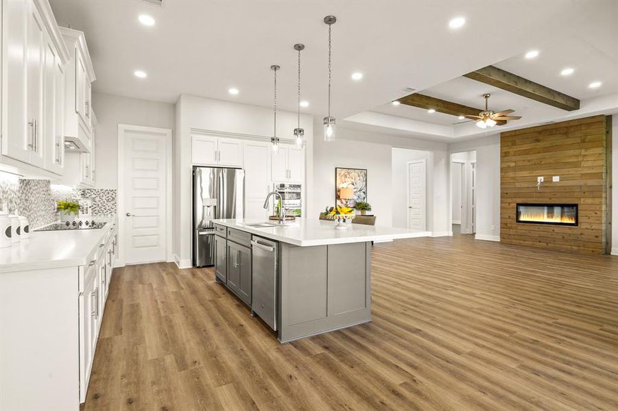 This angle showcases the countertop overhang on the island, providing an opportunity for additional seating. In fact, some would consider this the best seat in the house thanks to the probability of getting to taste test goodies right out of the oven.