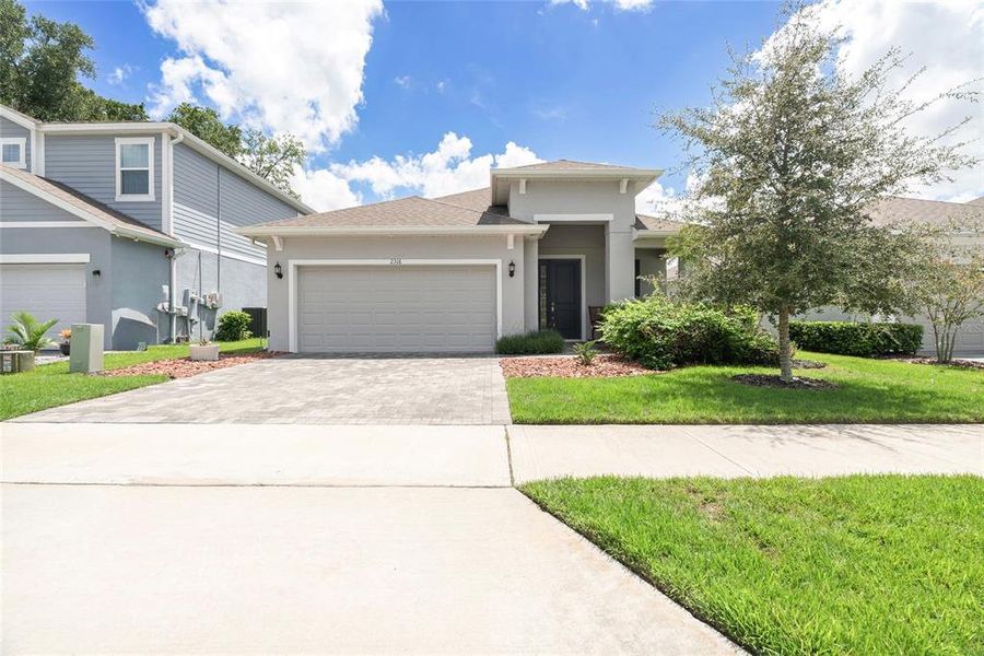 Front exterior of a new home in Summerbrooke, Mount Dora, FL, highlighting curb appeal (Image 25). Front exterior of a new home in Summerbrooke, Mount Dora, FL, highlighting curb appeal (Image 25).