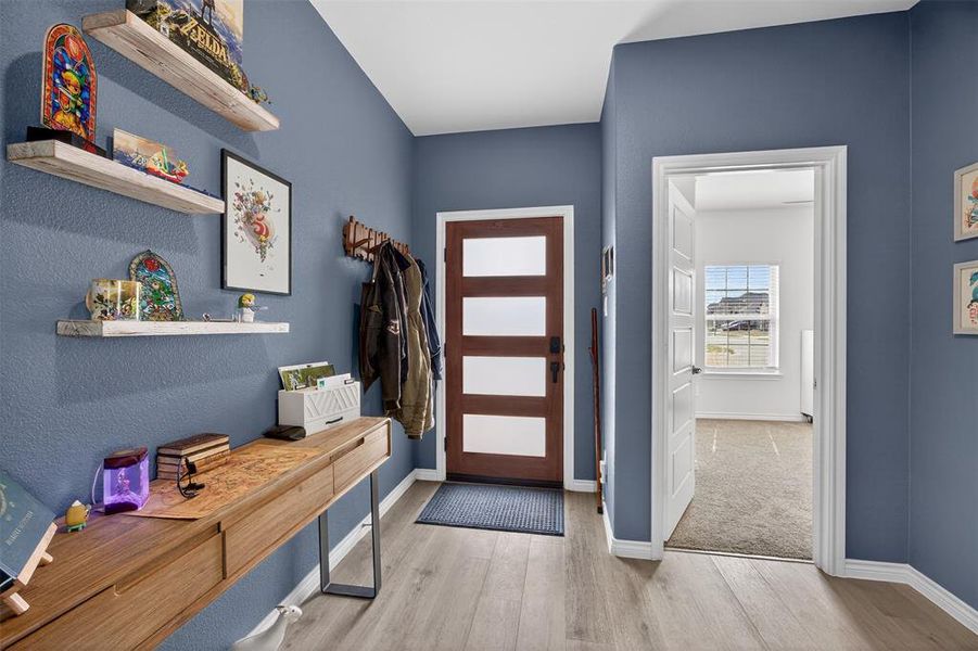 Entrance foyer with light wood finished floors and baseboards