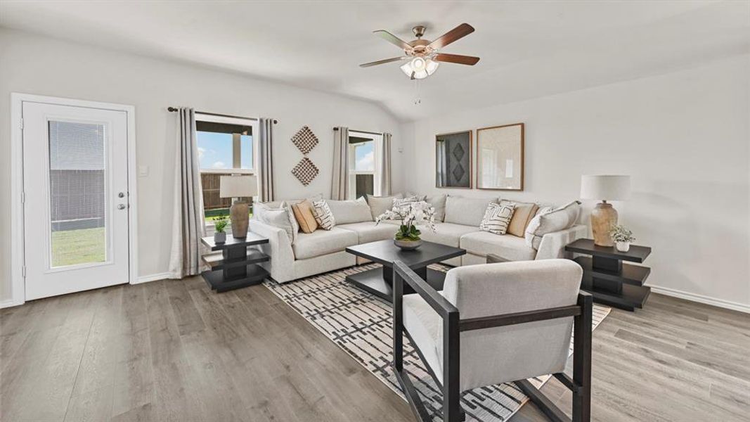 The living area features light-colored walls and wood-look flooring, creating a bright and open atmosphere