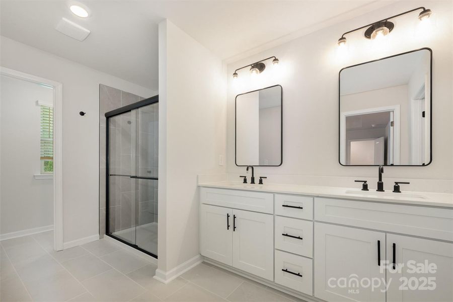 Primary bathroom w/ double vanity. Representational Photo.