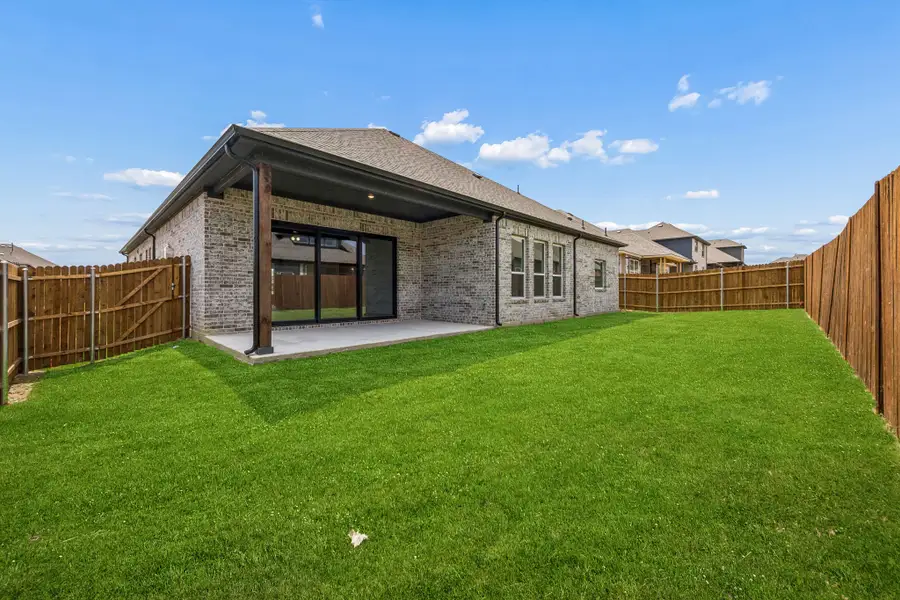 Exterior details and patio area of a home in Country Lakes, Denton (Image 21).