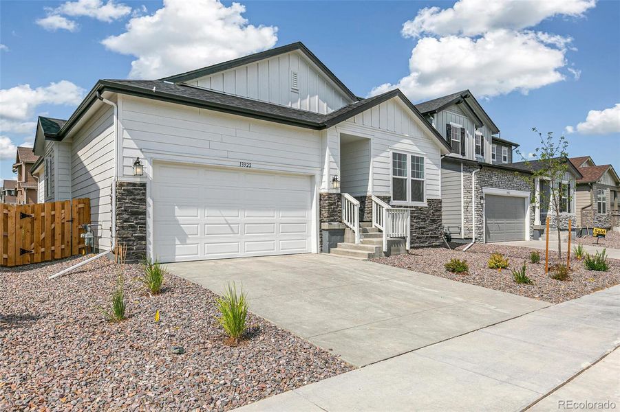 Front exterior of a new home in Turnberry, Commerce City, CO, highlighting curb appeal (Image 1). Front exterior of a new home in Turnberry, Commerce City, CO, highlighting curb appeal (Image 1).