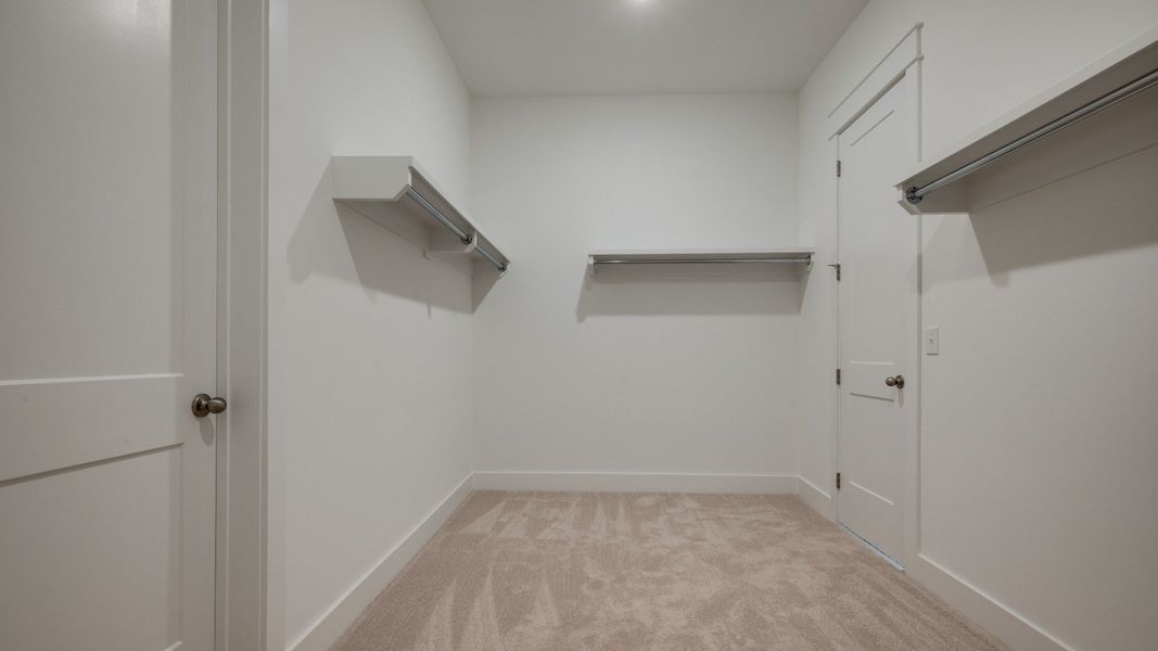 Large walk-in closet with various storage usages