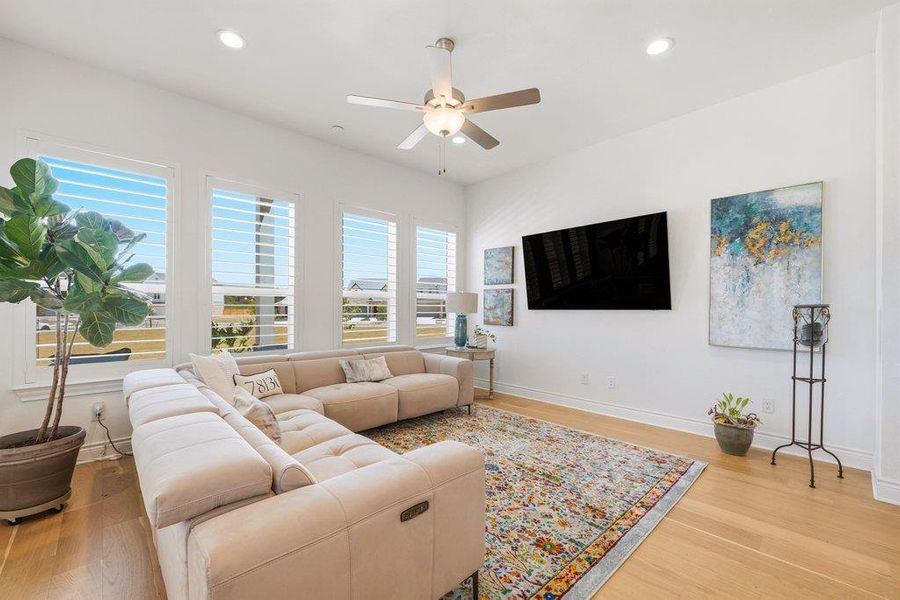 High ceilings and tall shuttered windows frame this inviting space with elegant hardwood flooring. High ceilings and tall shuttered windows frame this inviting space with elegant hardwood flooring.