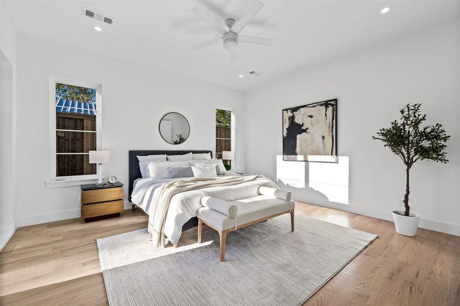 Bedroom with ceiling fan and light hardwood / wood-style floors