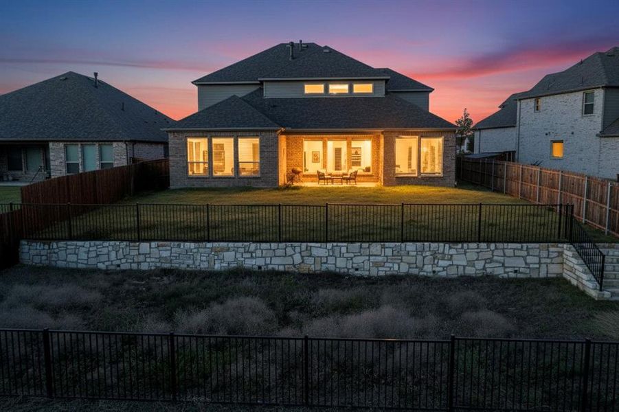 Rear view of house featuring a fenced backyard and a patio