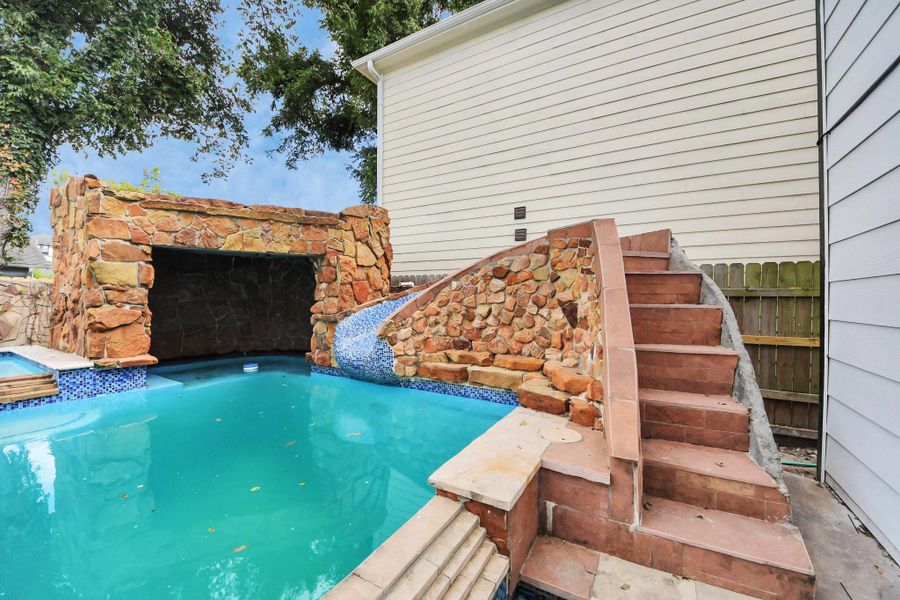 The custom-built rock grotto creates a charming and private oasis, while the slide provide hours of outdoor fun! The custom-built rock grotto creates a charming and private oasis, while the slide provide hours of outdoor fun!