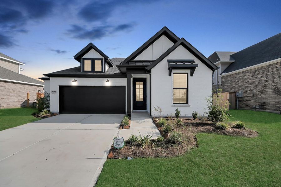 Front exterior of a new home in Arabella on the Prairie: Premier Collection, Richmond, TX, highlighting curb appeal (Image 26). Front exterior of a new home in Arabella on the Prairie: Premier Collection, Richmond, TX, highlighting curb appeal (Image 26).