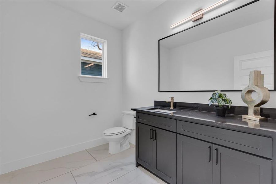 Bathroom featuring vanity and toilet