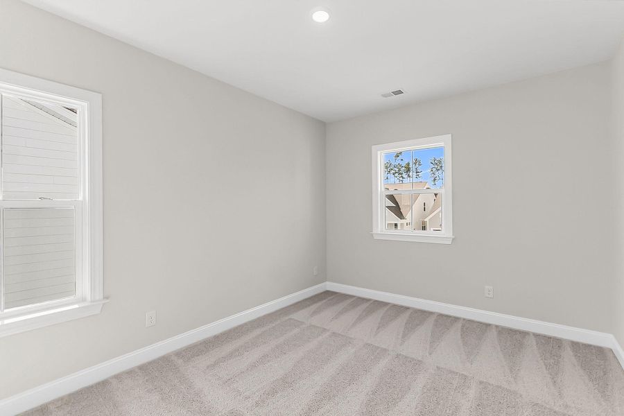 Spacious, unfurnished interior of a new home in Tidewater at Lakes of Cane Bay, Summerville (Image 50).