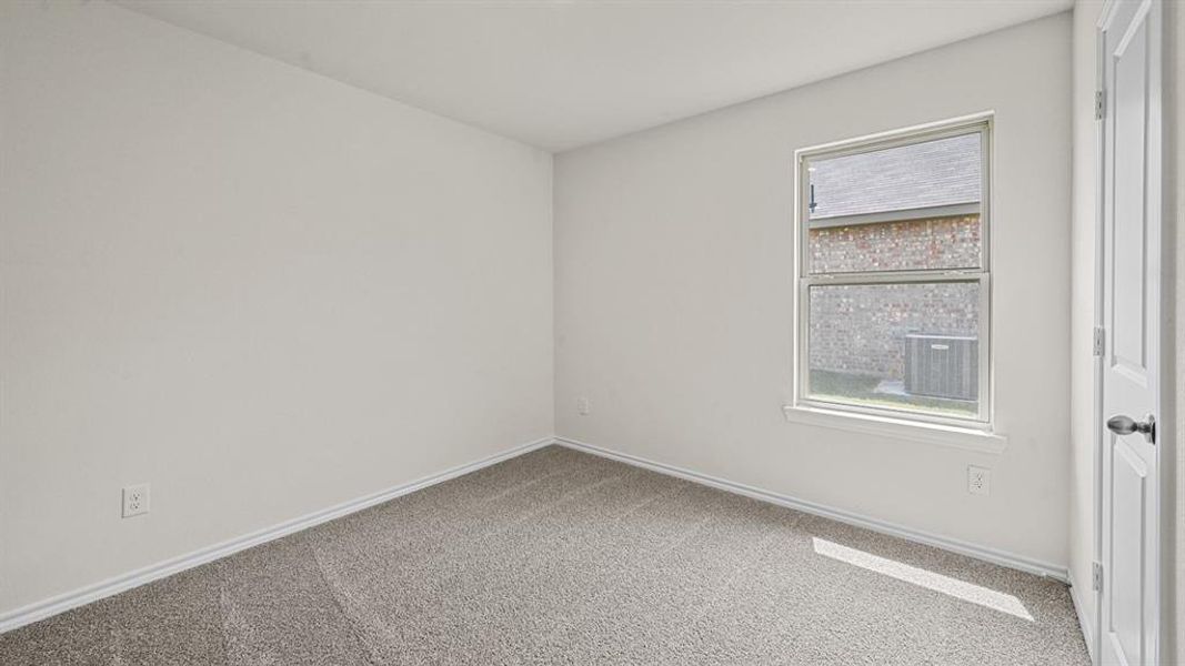 Empty room with light carpet and baseboards