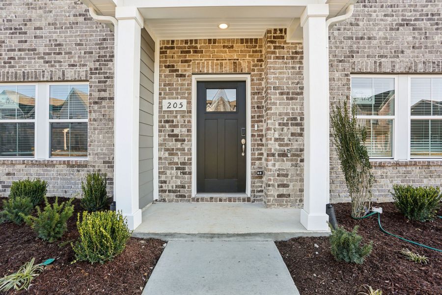 Exterior details and patio area of a home in Greystone - Highland Townhomes, Smyrna (Image 3).